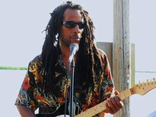 One Love Reggae Band guitarist and vocalist performing live